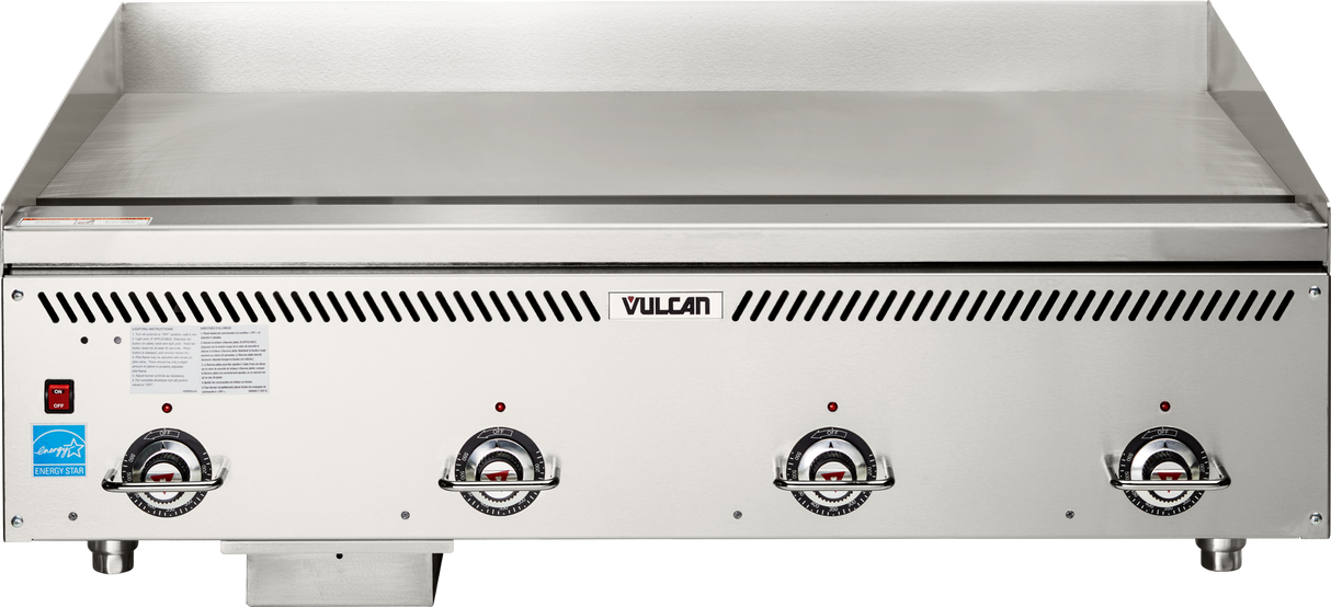 A commercial countertop gas griddle with three front control knobs, a VULCAN logo in the center, a smooth heavy duty griddle surface, and vented slits above the knobs. Features a blue certification sticker on the lower left front.