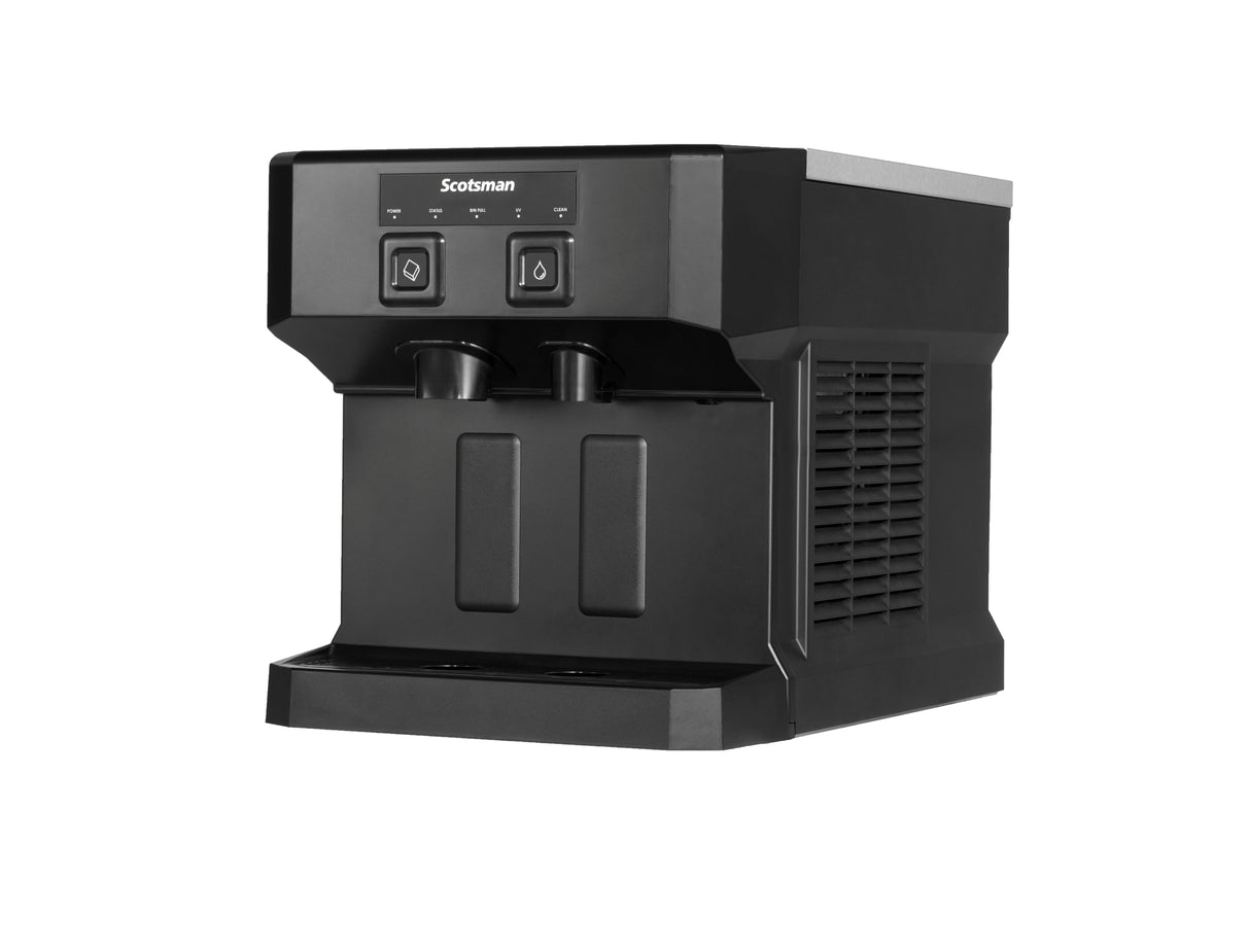 A black Scotsman nugget ice dispenser and water machine with two push-button controls, two dispensing nozzles, and a rectangular drip tray, shown angled on a white background.