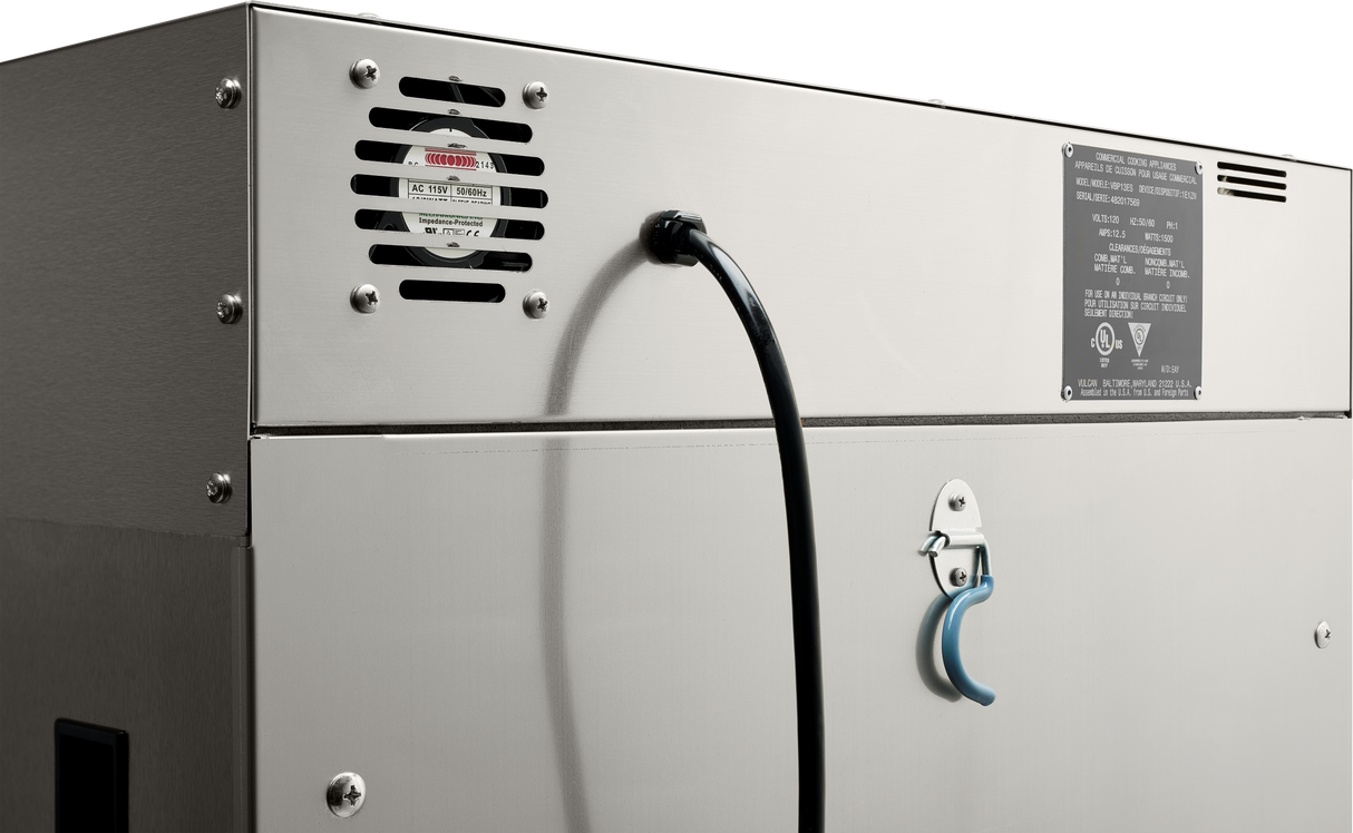 Close-up of the back side of a stainless steel holding cabinet, showing a black power cable, ventilation fan with warning label, metal panel with technical information, and a blue lever attached to a latch.