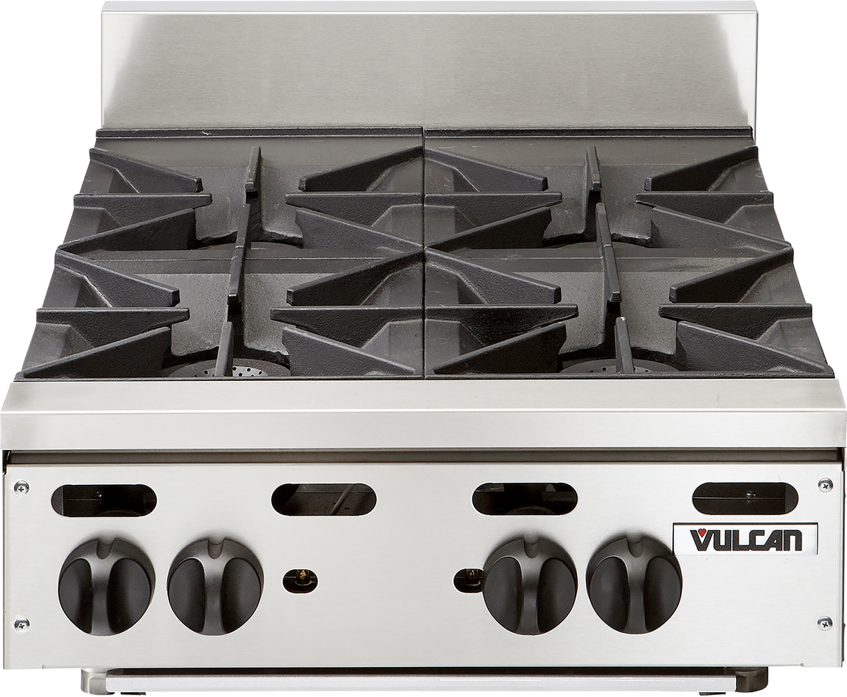 A stainless steel Vulcan countertop gas burner stovetop with four black cast iron burners and large control knobs on the front panel. It features angular grates, a minimalist design, and the Vulcan brand logo in the lower right corner.