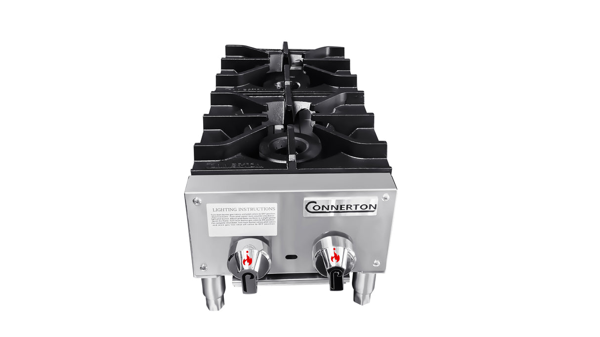 A stainless steel Connerton countertop gas stove with 2 burners, each controlled by a red-marked knob. Lighting instructions are on the front, and the stove stands on four metal legs against a white background.