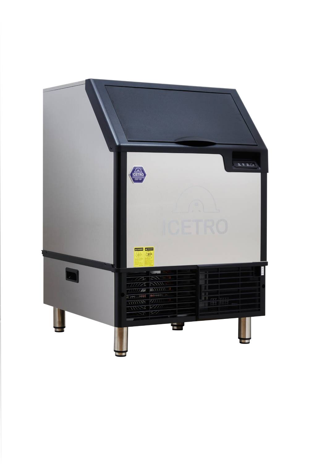 A commercial cube-style ice maker with a stainless steel exterior, black lid, front vents, warning labels, and the brand name ICETRO faintly visible on the front. The machine stands on four metal legs and boasts a modern, industrial design.