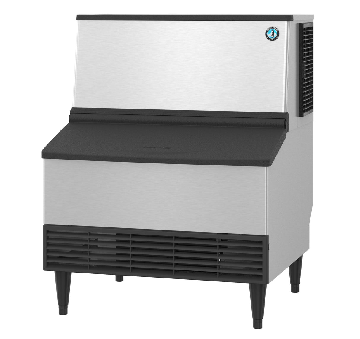 The Hoshizaki KM-301BAJ is a commercial stainless steel ice maker with a black front vent and lid, standing on four short legs. Its rectangular design efficiently produces crescent style cube ice for food service environments.