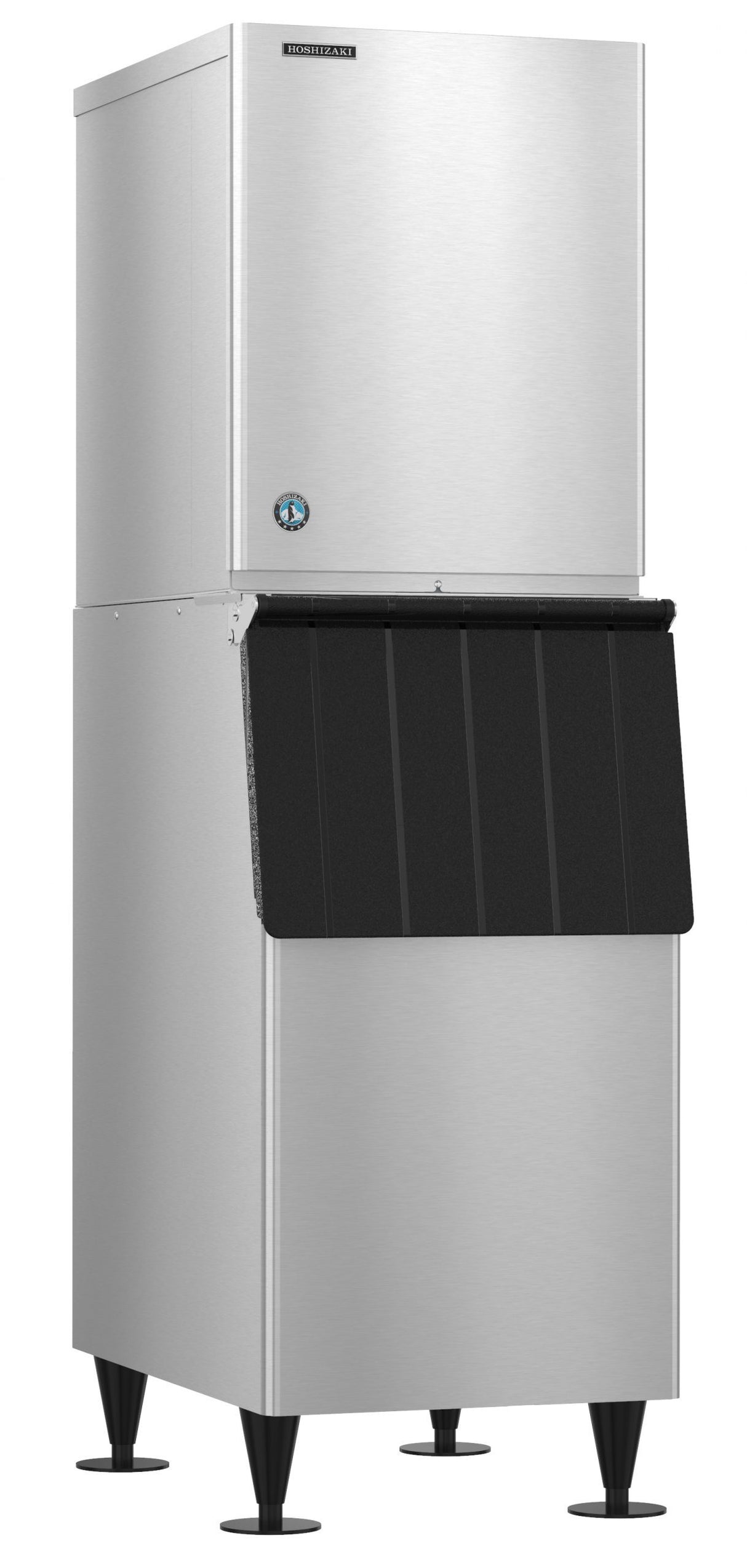 A large, industrial Hoshizaki stainless steel ice maker stands on four legs. The upper section produces crescent cube ice, while the lower section features a black, slanted door for easy access to the stored ice inside.