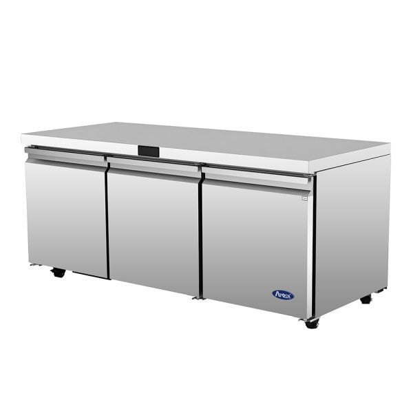 A commercial Atosa AUR72SD stainless steel undercounter refrigerator with three front doors, black handles, a smooth flat top, and small wheels. The clean, industrial unit features the Arctic Air logo on the lower right front panel.