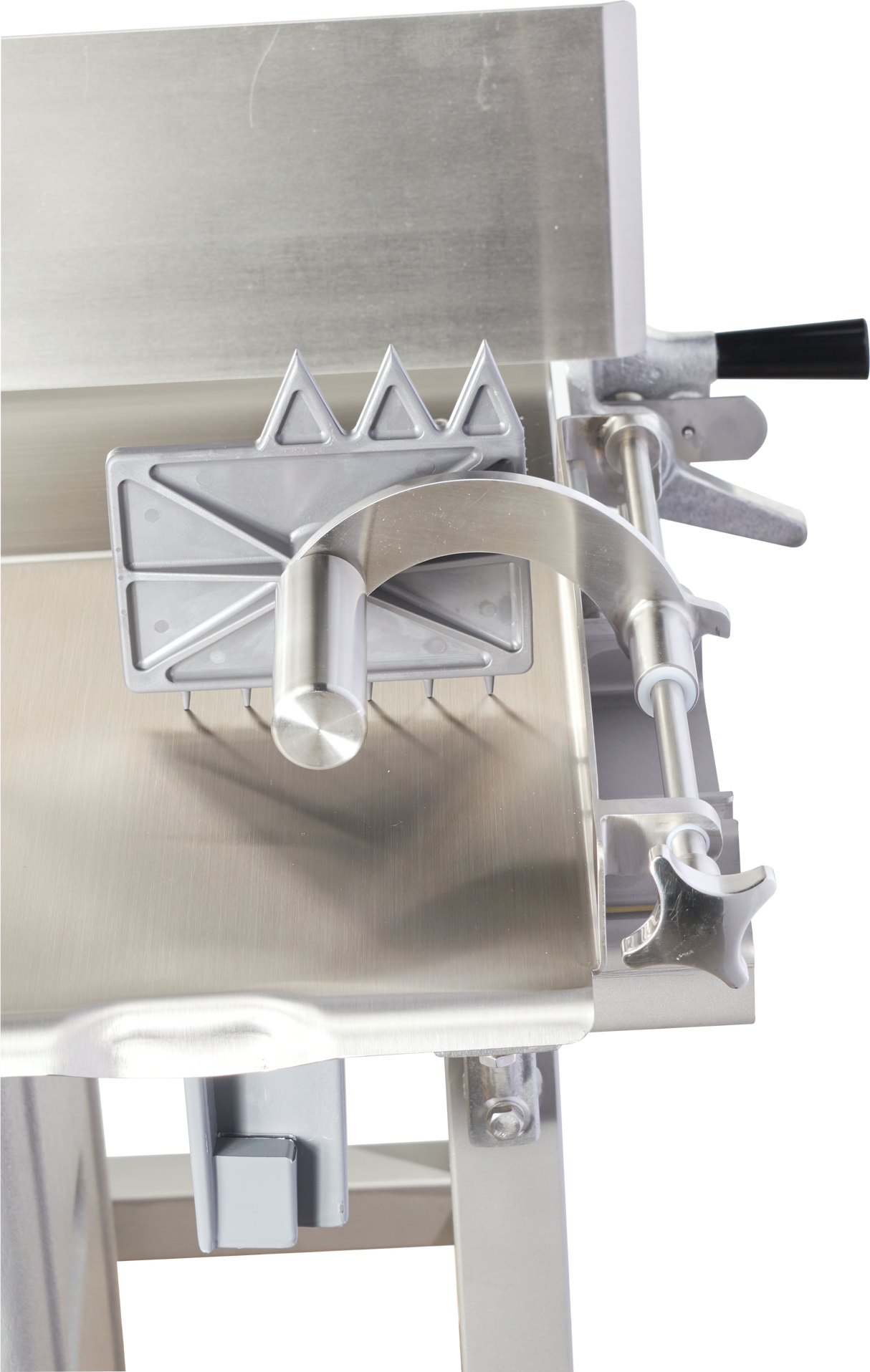 A close-up of a Hobart 6801-18IP stainless steel sausage stuffer with an integrated pusher, featuring a handle, gears, and triangular metal teeth on a sliding mechanism atop a shiny metal surface with clean, industrial lines.
