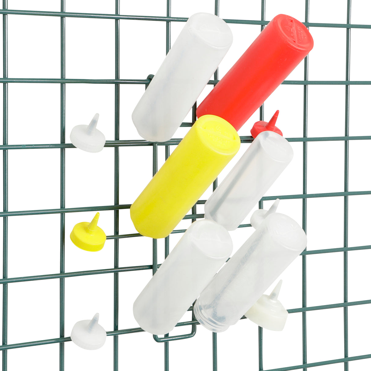 Four clear plastic tubes, one yellow tube, and one red tube are vertically attached to a green wire grid—like a SmartWall Bottle Drying Rack offering antimicrobial protection. Three round pushpins—two white and one yellow—are also pinned to the staggered arrangement.