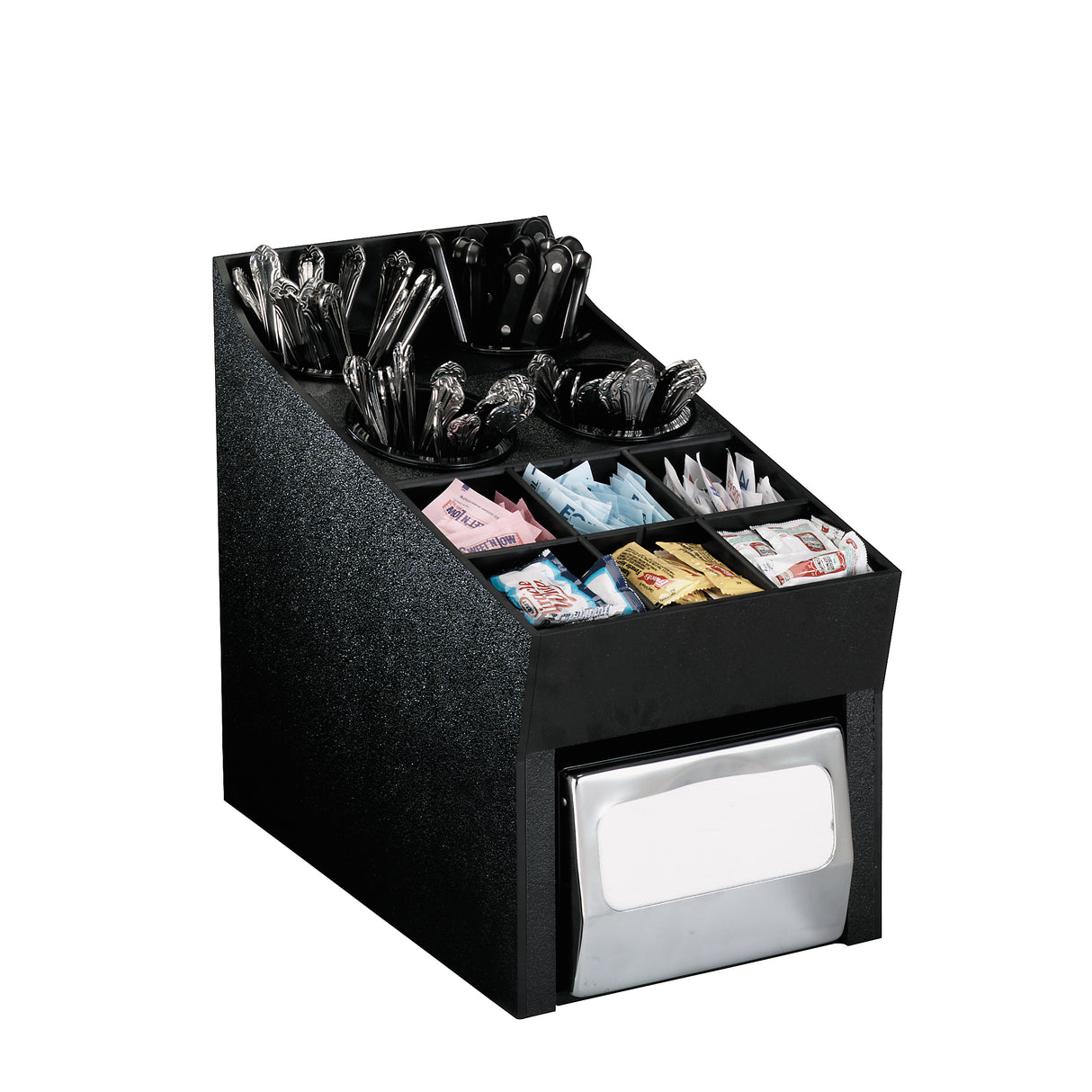 A black condiment organizer holds compartments of wrapped plastic utensils, napkins, and various packets of sweeteners and condiments. The front bottom section features a metal napkin dispenser. The background is plain white.