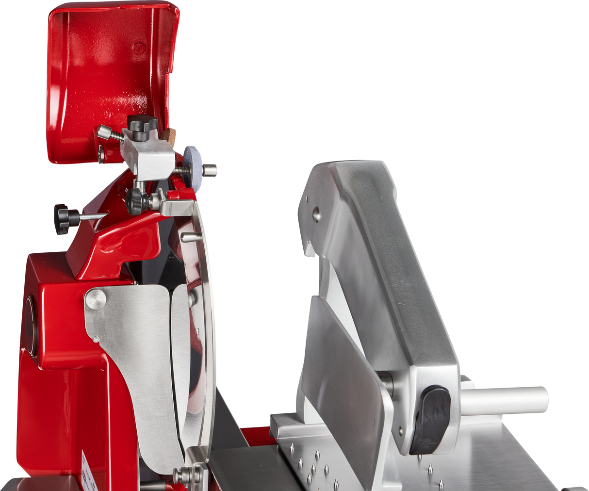 Close-up of a commercial Fly Wheel Slicer with a shiny red and silver body. The Berkel slicer features a chromium-plated carbon steel knife, black handle, and precise adjustment knobs—ideal for slicing meats or cheeses in any deli or kitchen setting.