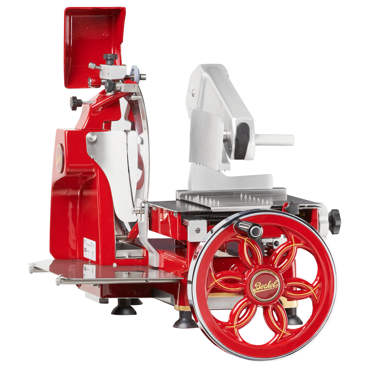 A vintage-style, red and silver Fly Wheel Slicer with a large hand-crank wheel labeled Berkel. It features a shiny chromium-plated carbon steel knife, black tray, and a classic retro industrial design with metal and plastic parts.