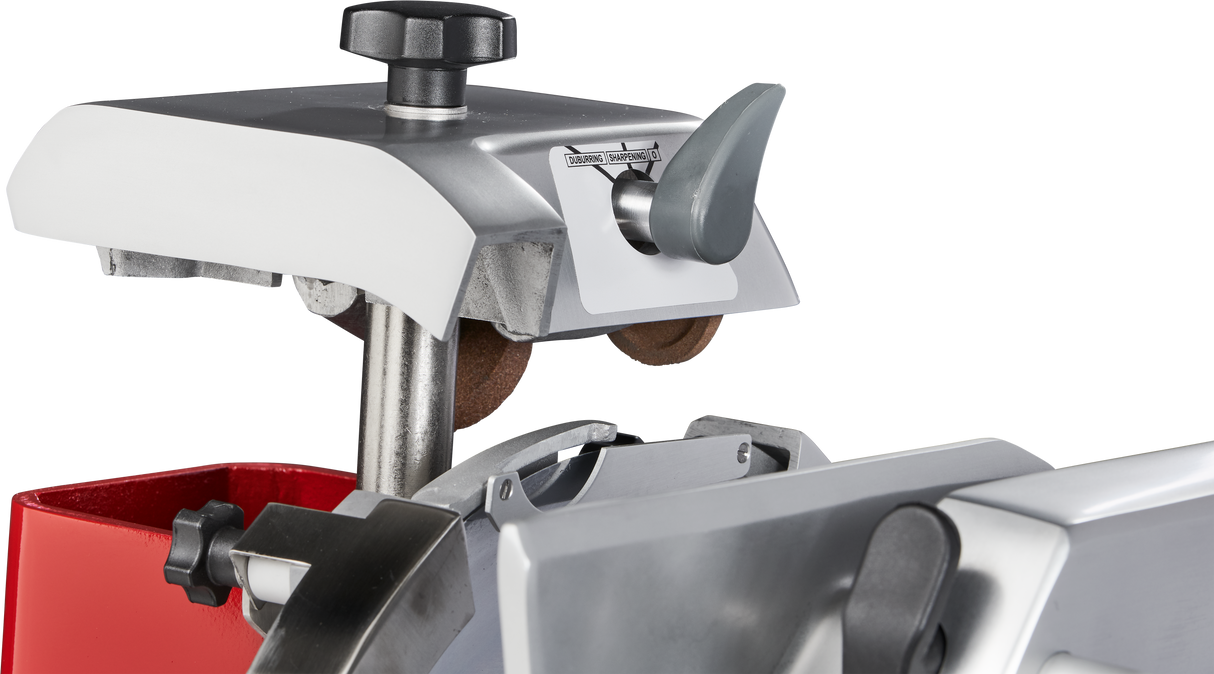 Close-up of a Berkel 330M Fly Wheel Slicer with a chromium-plated carbon steel knife. The image highlights metal parts, rotary blade cover, adjustment knobs, and brown sharpening wheels on this sleek, industrial silver and red equipment.