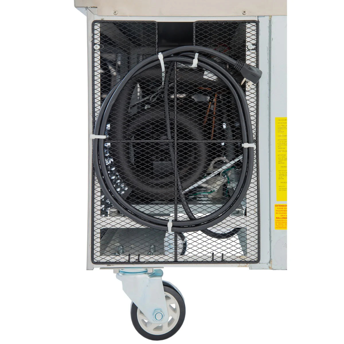 A close-up of a stainless steel refrigerated equipment stand shows a coiled black power cable secured by white zip ties. The unit features a large caster wheel, visible machinery inside, and a vertical yellow safety label on the right side.