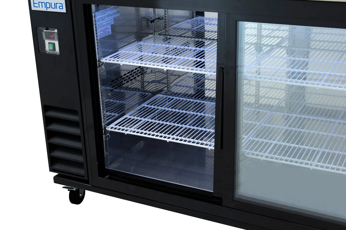 A close-up of an Empura Refrigeration Back Bar Cooler with sliding glass doors, revealing three empty white wire shelves inside. The black fridge features a control panel and vent on the left side and stands on caster wheels.