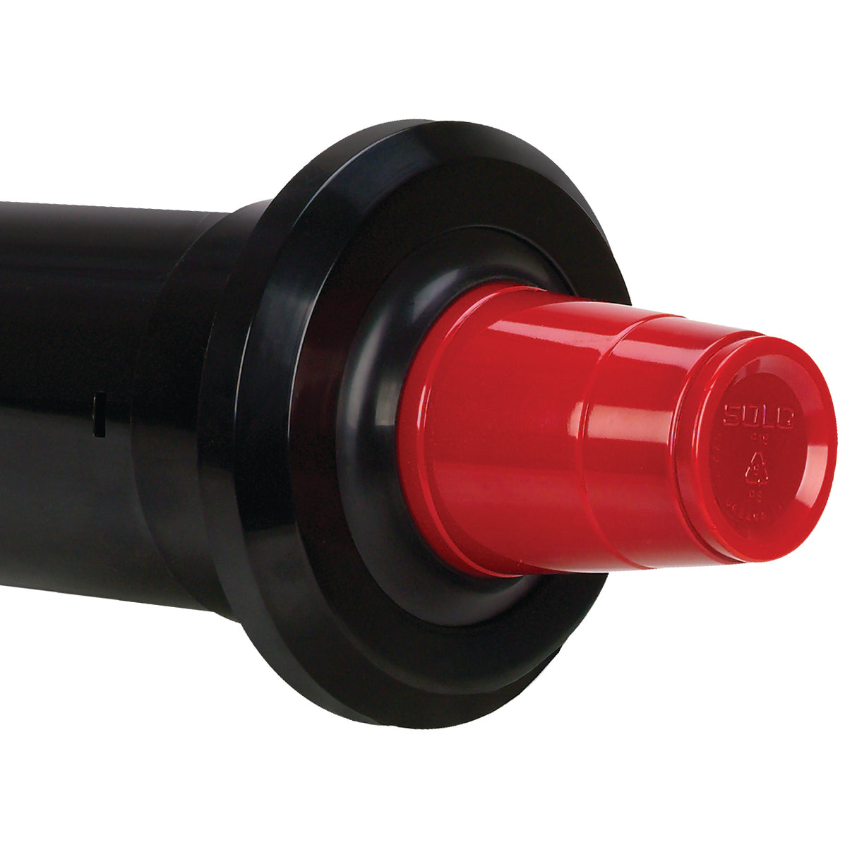 Close-up of a black cylindrical cup dispenser with a wide flange, ending in a red plastic cap. The cap has ridges and the word “SOLO” embossed on the end. Features an in-counter Perfect-Fit gasket system. Background is plain white.
