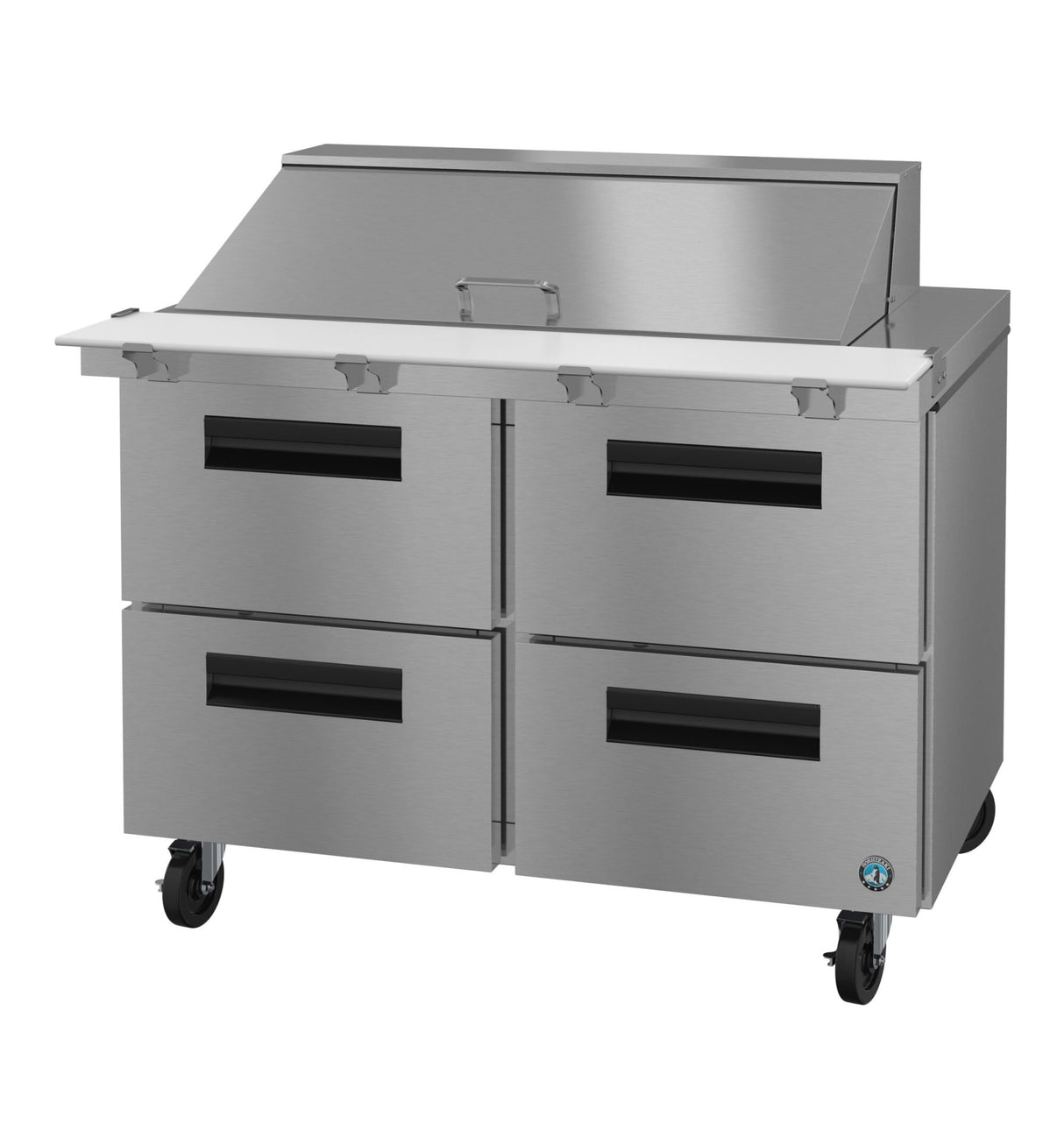 A stainless steel Mega Top Refrigerator prep table featuring four black-handled drawers, a white cutting board surface, a raised covered ingredient section at the back, and caster wheels. This unit offers modern industrial style with practical mobility.
