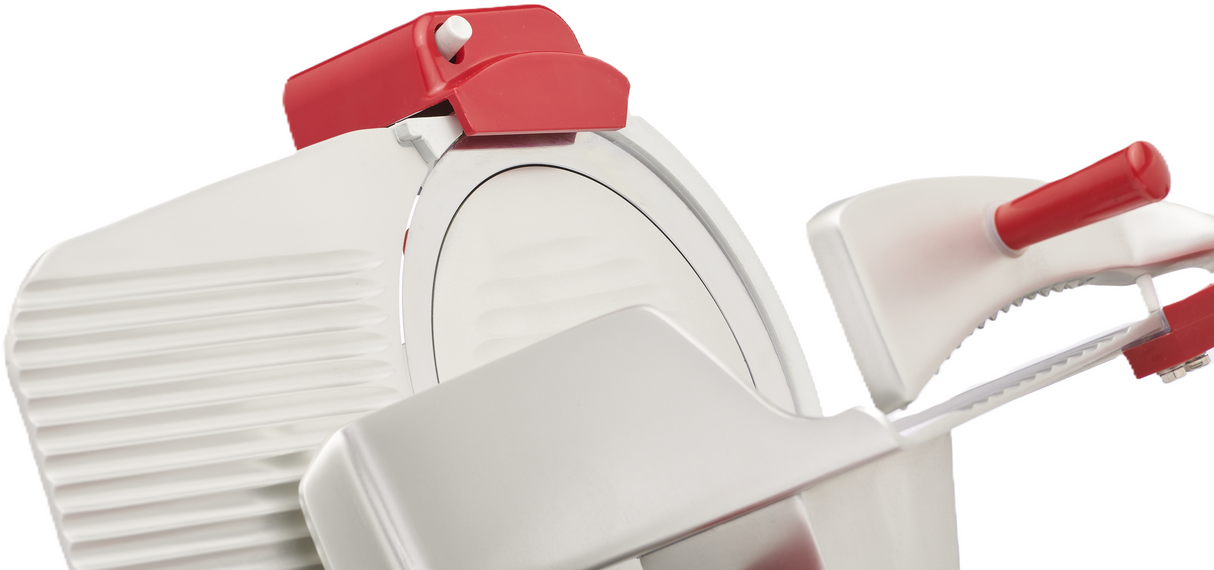 Close-up of a white and red Berkel B10-SLC gravity feed slicer, highlighting the circular serrated blade, food carriage, and handle. The modern design features ribbed detailing and bold red accents on the top and handle, set against a white background.