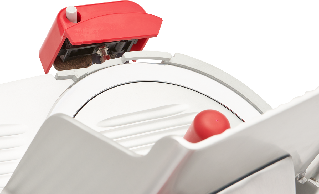 Close-up of a Berkel B12-SLC manual slicer with a round, serrated blade. The slicer features a red handle and safety guard. Its carbon steel knife is clean and shiny, set against a plain black background.