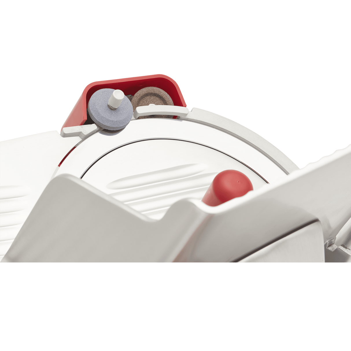 Close-up of a Berkel slicer, focusing on the 12 inch carbon steel knife with sharpening stones above it. The design features red, gray, and metallic components, with a protective guard partially covering the cutting edge.