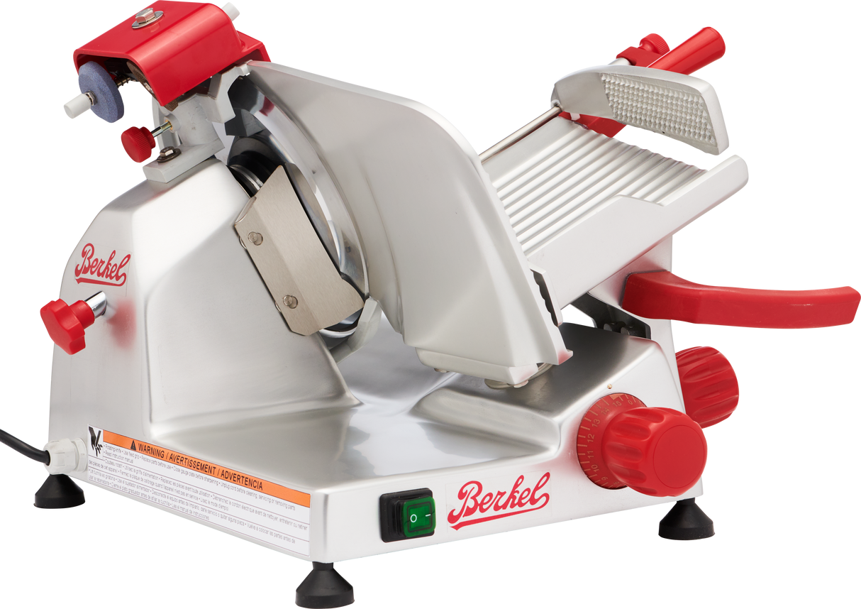 A Berkel slicer with red knobs and accents features a sharp circular blade, sliding food tray, grip-groove food holder, and power switch. This gravity feed slicer has a sturdy base and non-slip feet for safe, precise slicing.