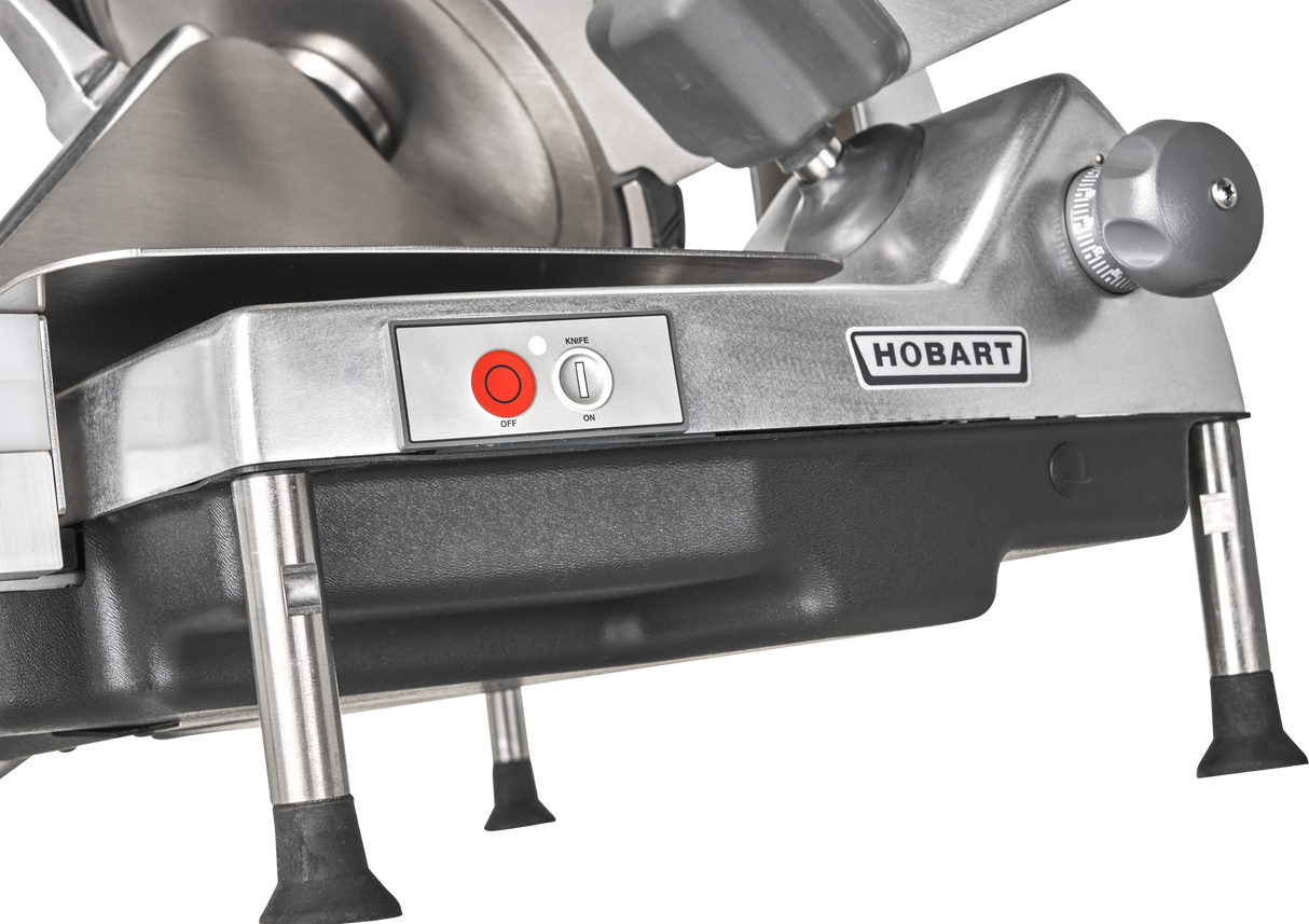 Close-up of a Hobart HS6-1PS Heavy Duty Meat Slicer base, featuring sturdy metal legs, red and white control buttons, the HOBART logo, and a stainless steel panel—showcasing its durable build and advanced 13 CleanCut Knife.