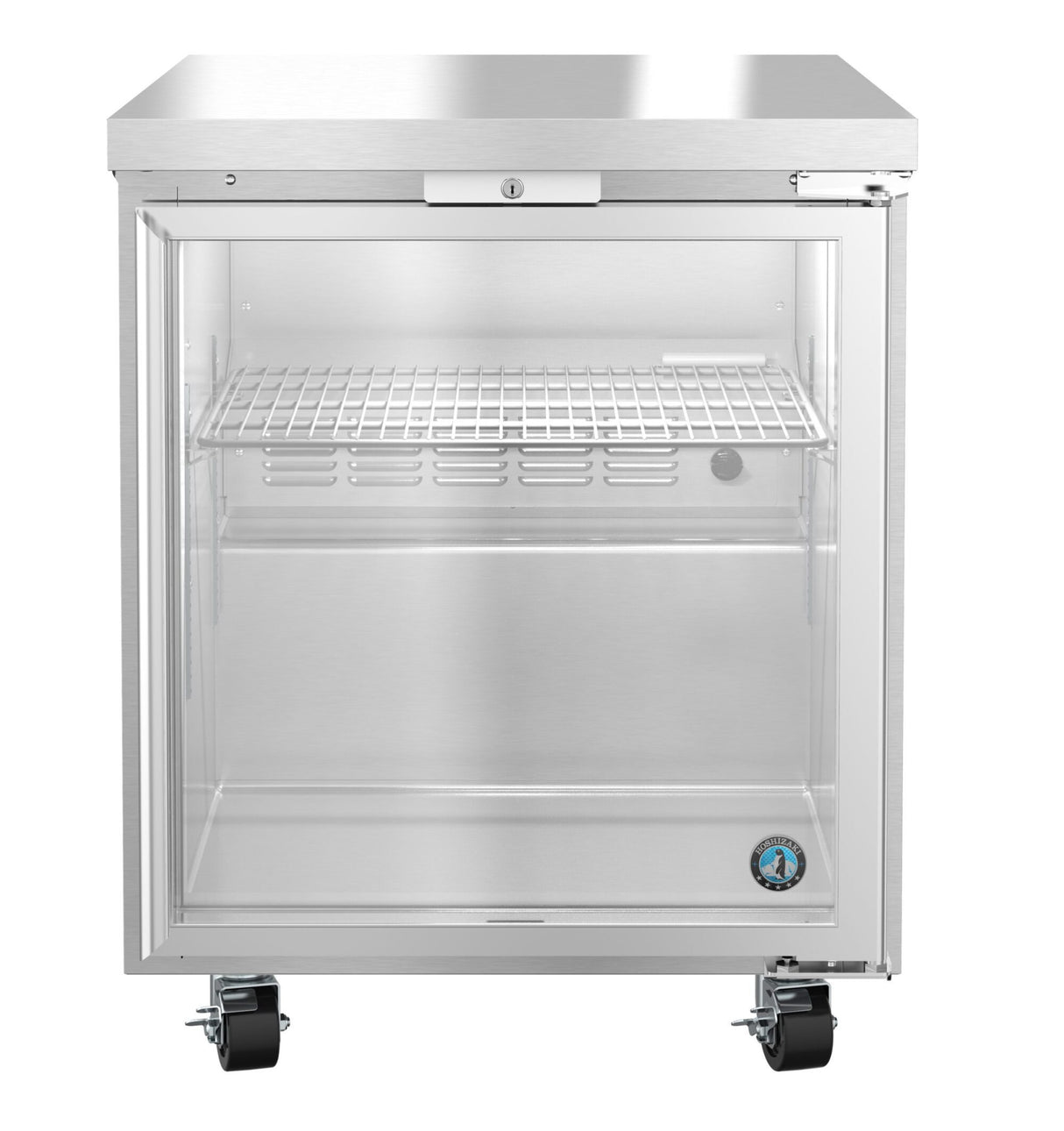 A stainless steel undercounter freezer with a transparent glass door, single wire shelf, and locking mechanism on top. The empty fridge stands on four black caster wheels, with a circular blue certification sticker on the bottom right corner.