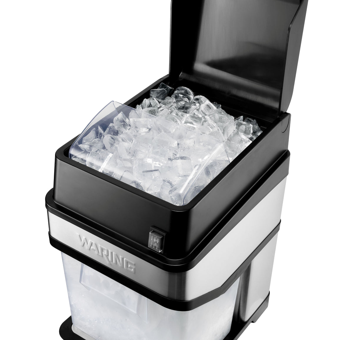 A stainless steel and black countertop ice crusher with its lid open, showing a bin filled with clear ice cubes. The lower section contains a transparent drawer for collecting ice. The brand name Waring is visible on the front.