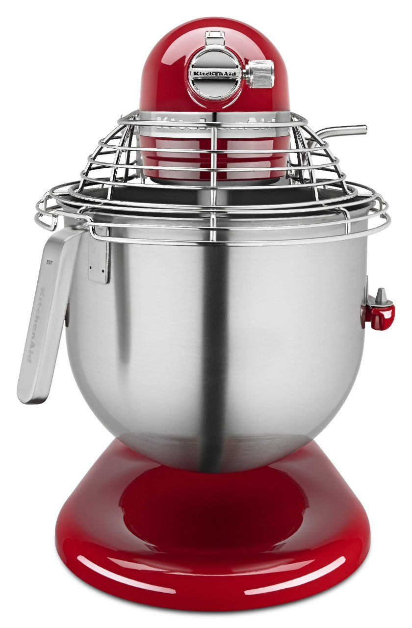 A red KitchenAid Commercial Stand Mixer with PowerCore technology features an 8 quart bowl, a metal wire safety guard, and a lever on the left. It sits on a glossy red base with a speed control knob and branded nameplate at the front.