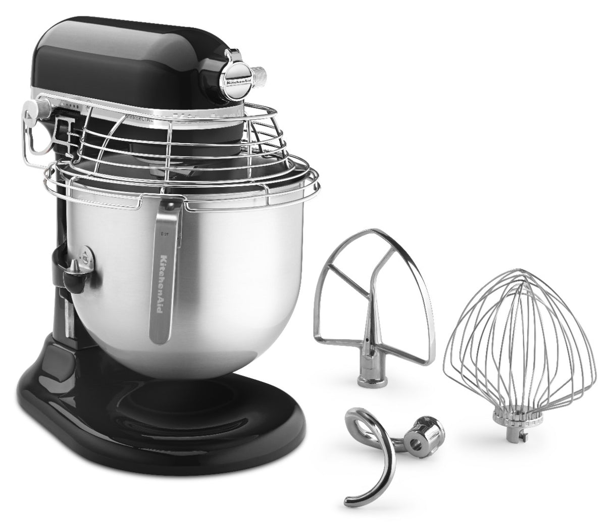A black and silver KitchenAid Commercial Stand Mixer with an 8 quart bowl and wire safety guard is shown. Three metal attachments—a flat beater, dough hook, and wire whisk—are placed beside it on a plain white background.