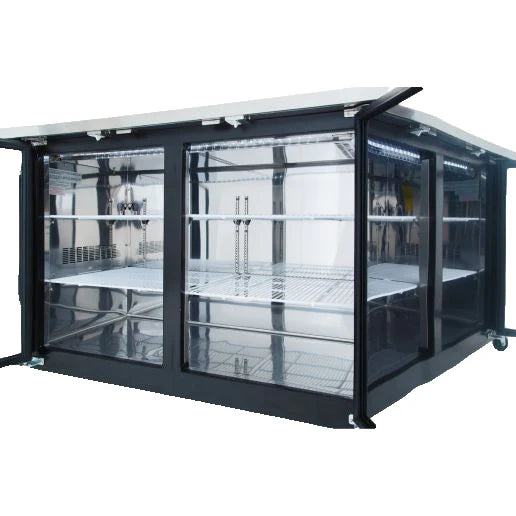 Large, rectangular glass display case with black frame, sliding doors, and metal shelving inside. The case, similar to Empura Refrigeration back bar coolers, is empty, well-lit, and sits on small wheels. The white top contrasts with transparent sides and shelves.