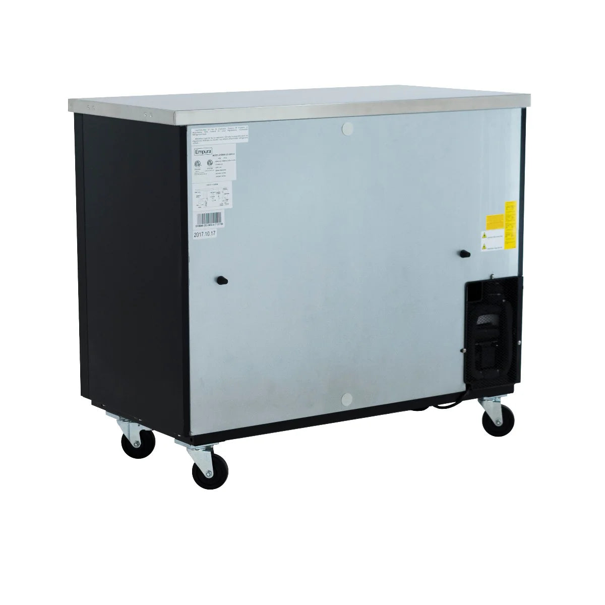 A large, stainless steel back bar cooler with black sides and a flat top sits on four caster wheels. It features ventilation grilles, commercial refrigeration labels on the front, handles, and an access panel on the right side.