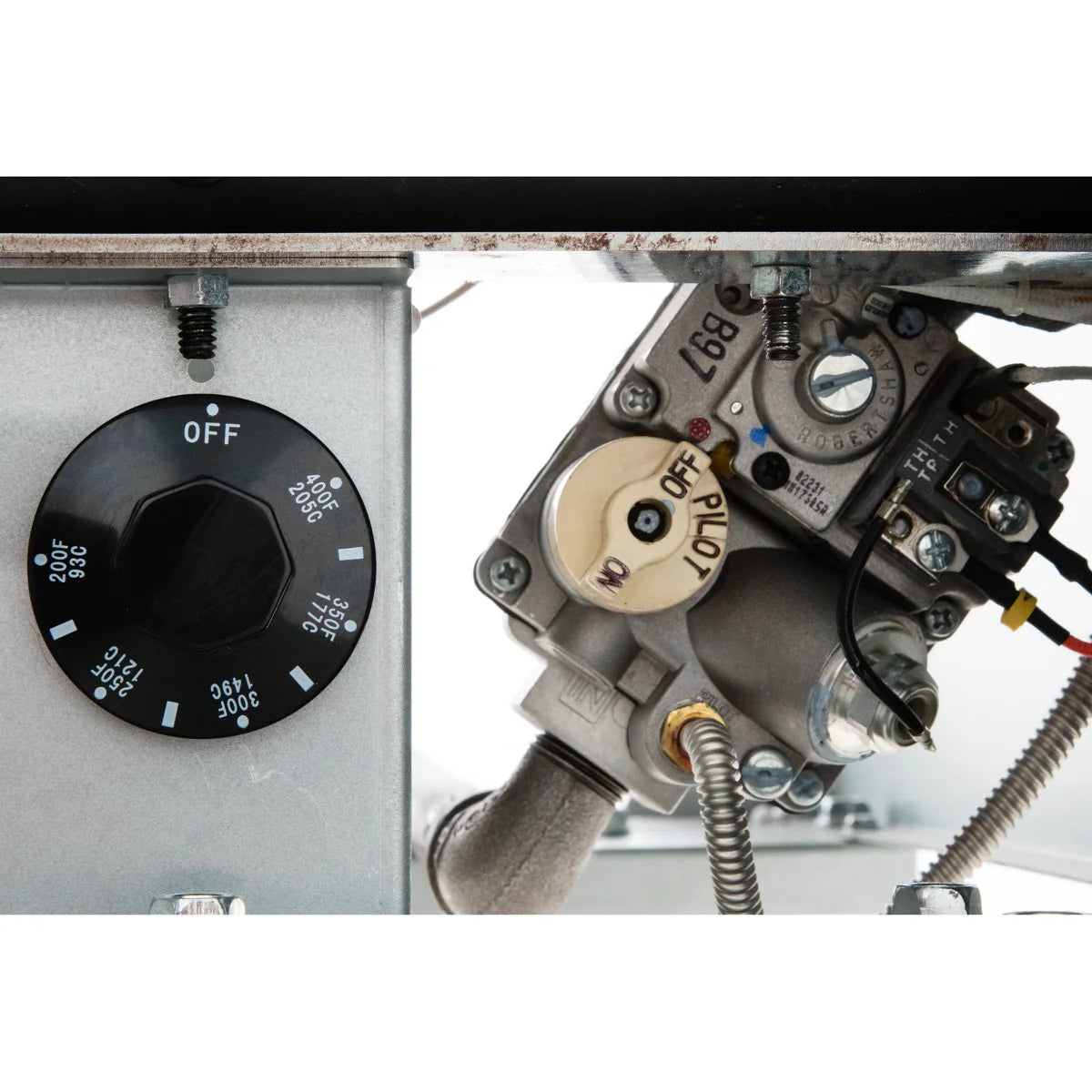 Close-up of a mechanical gas control assembly on a commercial fryer, featuring a black temperature dial labeled in Fahrenheit and OFF, plus a metallic gas valve with attached wires and a tan knob marked OFF and PILOT, designed for 50lb capacity units.