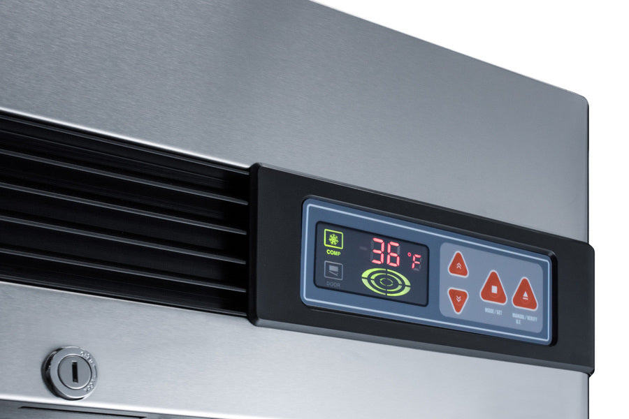 Close-up of a stainless-steel commercial refrigerator control panel displaying 36°F, various orange and green indicator lights, and buttons for temperature adjustment. A keyhole is visible on the left side under the vent, highlighting the secure and precise controls found on this premium stainless steel refrigerator.