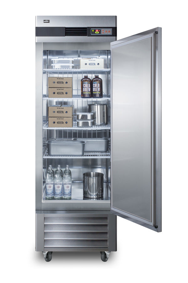 A commercial reach-in refrigerator with the door open, showing shelves stocked with boxes, metal containers, two large cold brew coffee jugs, three glass bottles, and a metal canister. The interior of this stainless steel refrigerator is well-lit and organized.