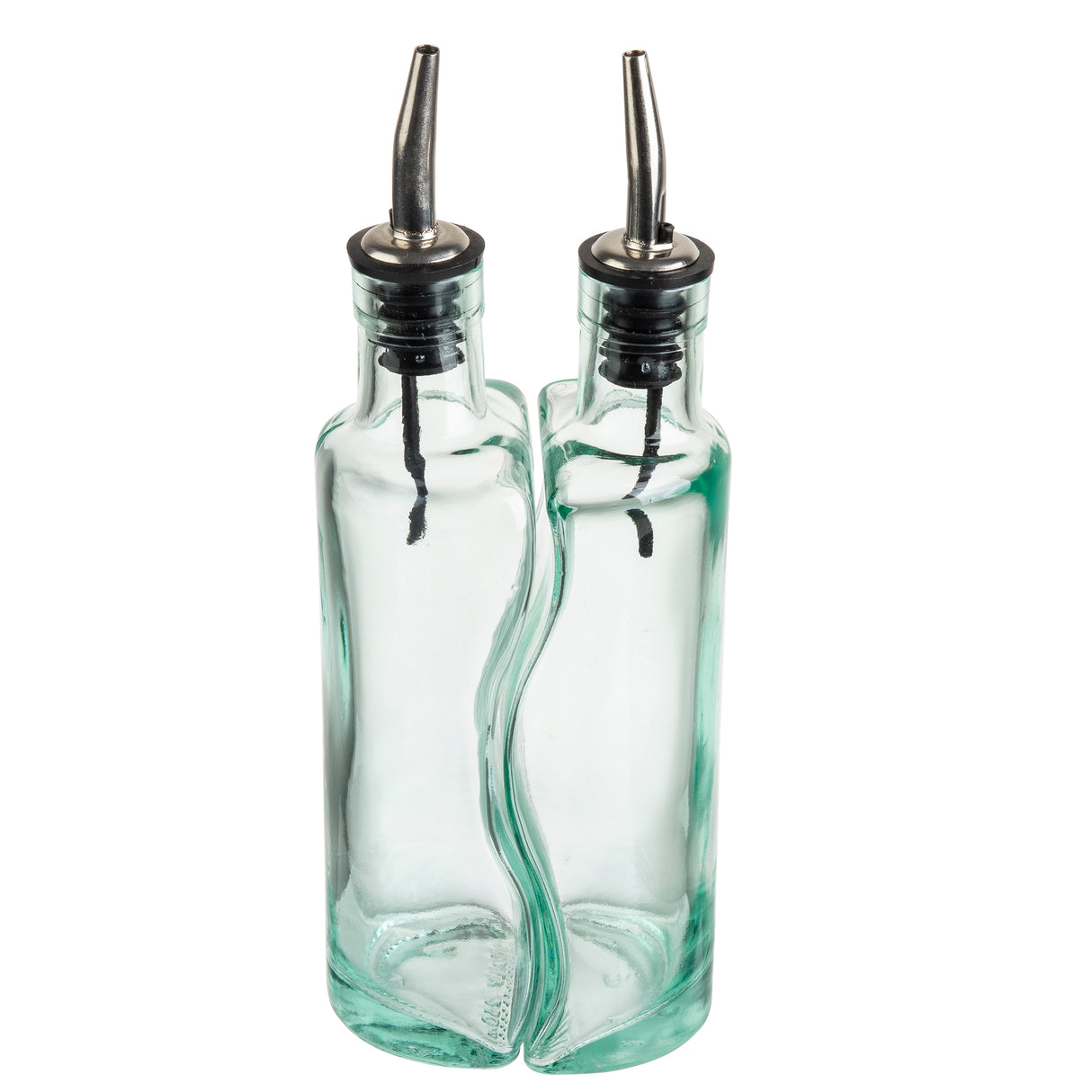 Two clear glass oil dispensers with curved sides and stainless steel pourers are positioned closely together. Each bottle has a black rubber stopper, and their design allows them to fit together in a wavy, interlocking manner.