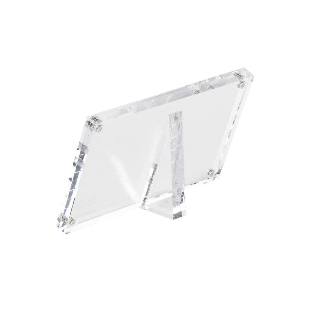 A clear acrylic sign holder stands at an angle, supported by a triangular back stand. The rectangular frame, with visible screws at each corner, is designed to securely display your photo or sign against a plain white background.