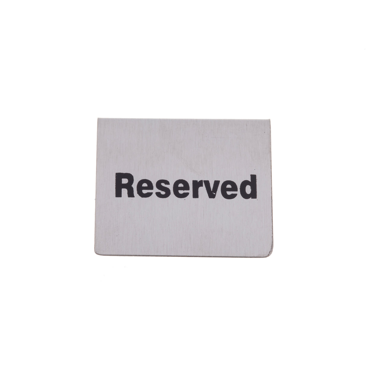 A rectangular stainless steel reserved sign with the word Reserved printed in bold black letters stands upright against a plain white background. The simple buffet tent style clearly indicates that a spot or table is set aside.