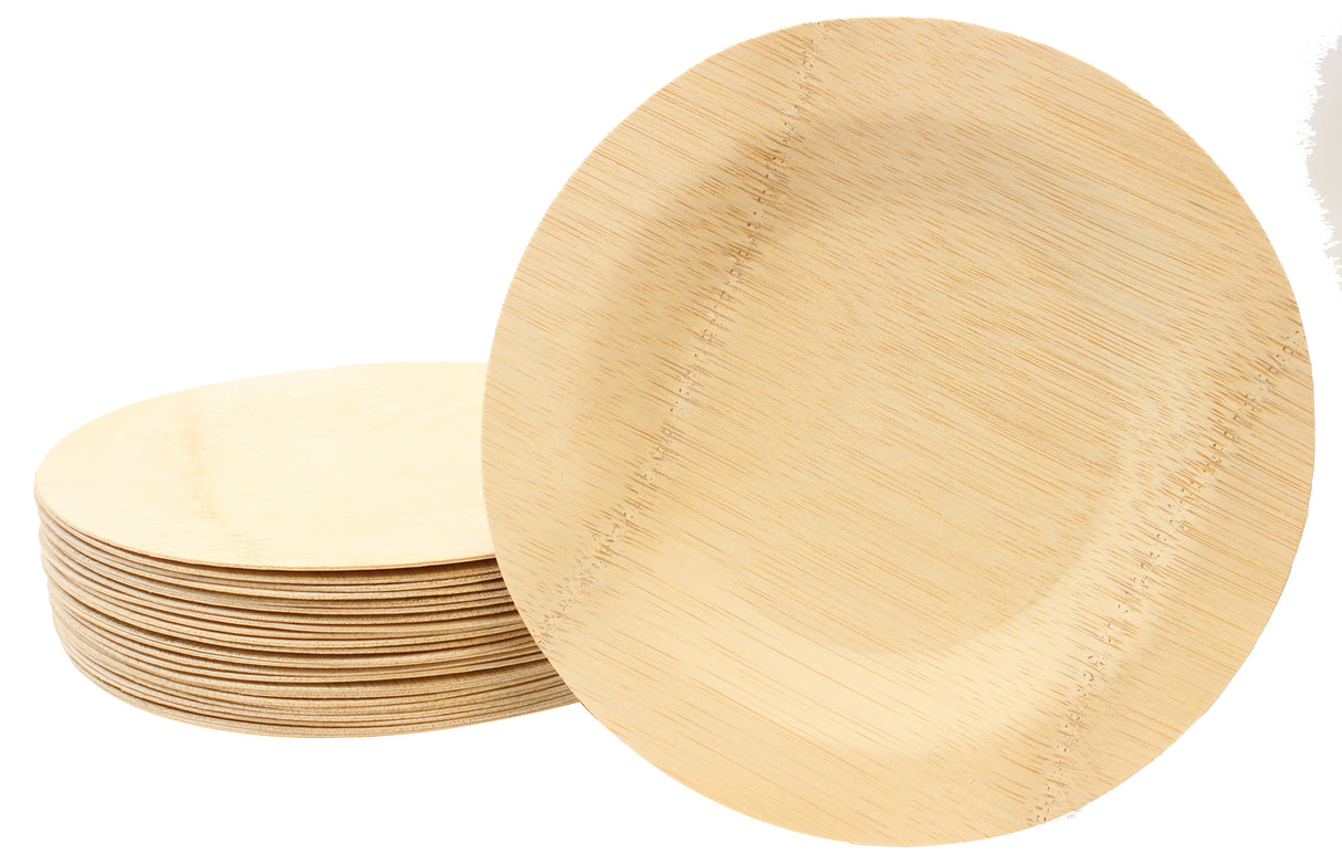 A stack of round bamboo plates, each a 7 inch plate, made from bamboo or a similar natural material. One disposable bamboo plate is propped upright, showing its shallow, smooth surface and visible wood grain with subtle stitching detail.