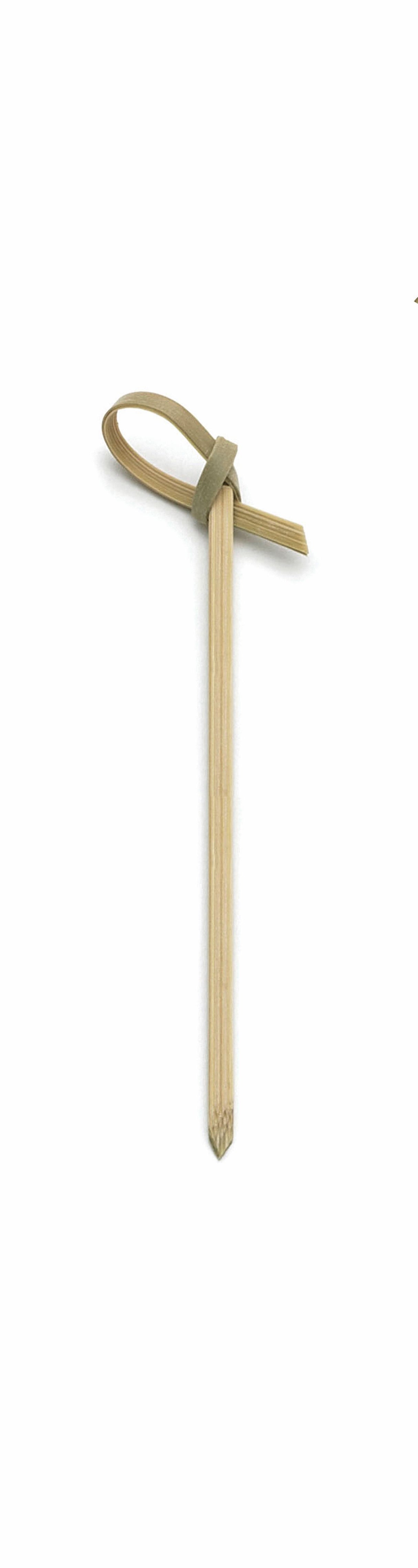 A single TableCraft Knot Pick stands vertically on a plain white background. This bamboo pick features a pointed end and a decorative loop at the top, elegantly tied from a thin strip of bamboo.