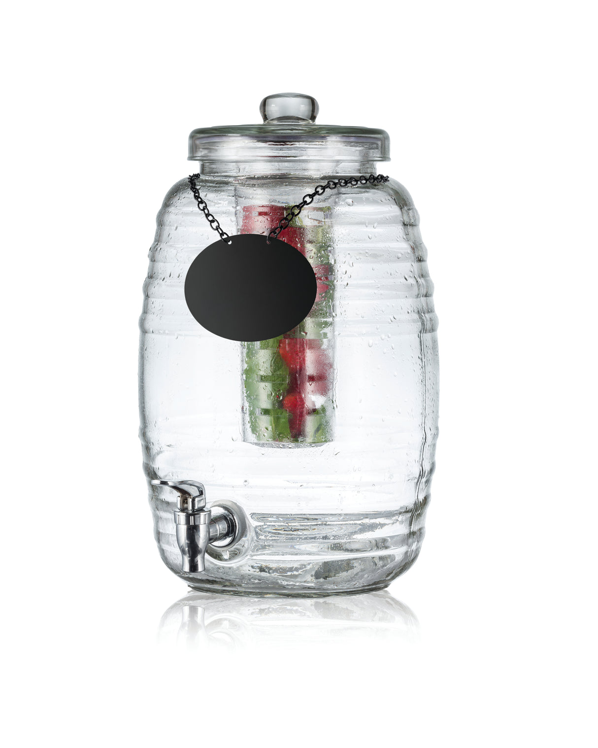 A clear ribbed glass beverage dispenser with a spigot at the bottom, lid on top, and black round label on a chain. Inside, cucumber, strawberries, and mint infuse the water. The background is white—perfect as a stylish TableCraft Beehive Beverage Dispenser.