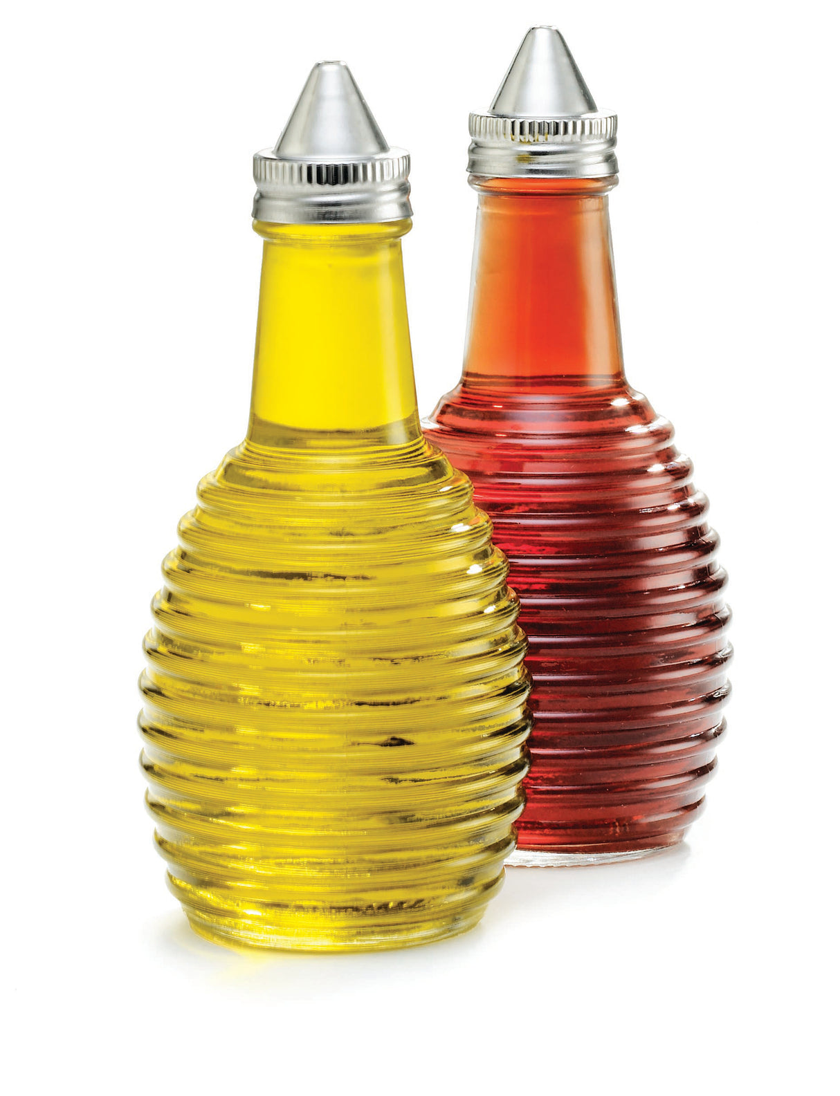 Two ribbed glass bottles from the Beehive Collection, designed as Oil/Vinegar Dispensers by TableCraft Products, are shown. One holds yellow oil and the other red vinegar, both set against a white background.