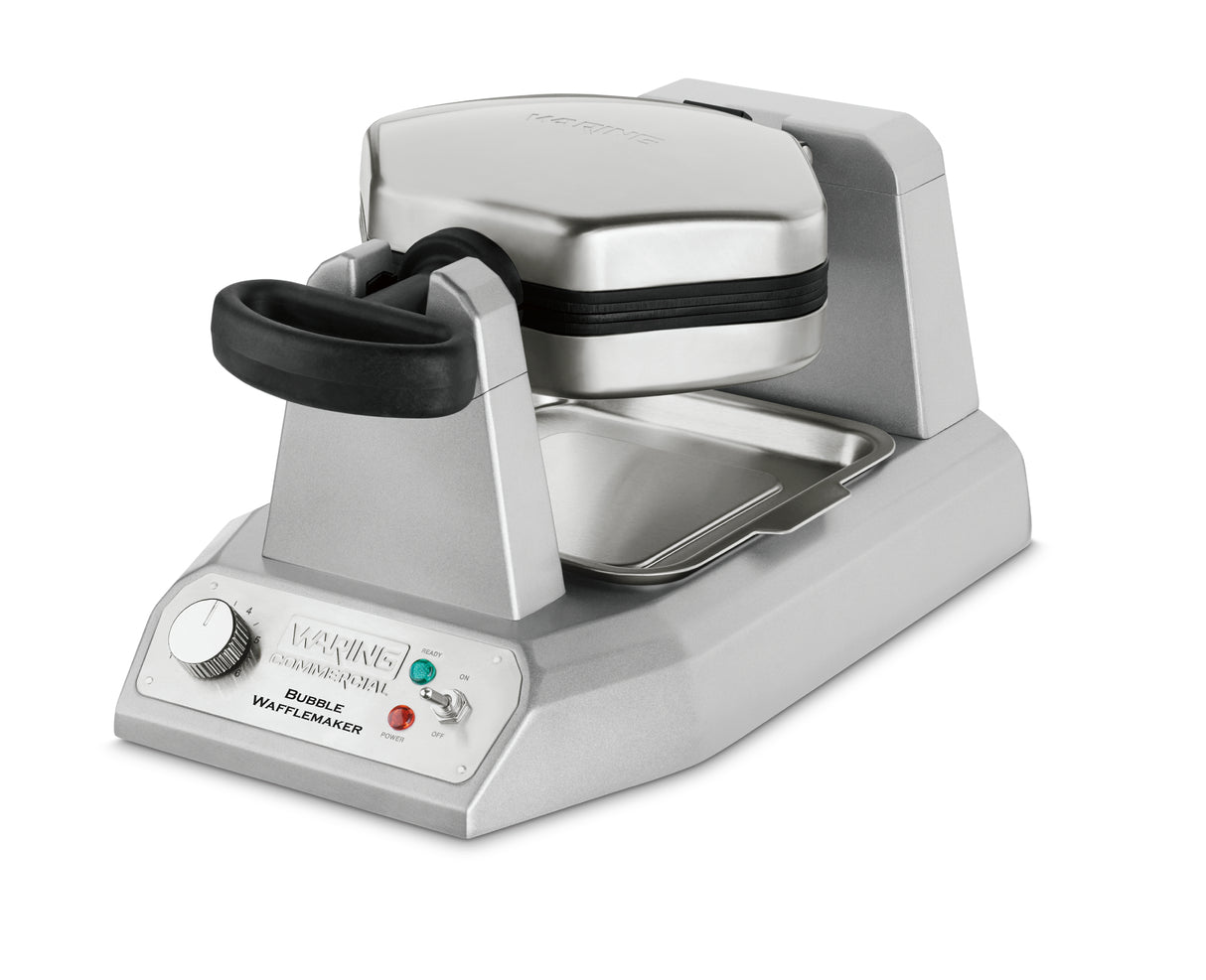 A silver rotating commercial waffle maker, the Waring WBW300X features a black handle, control dial, indicator lights, and the Waring logo. Its metal drip tray and sturdy, modern design make it ideal for frequent use.