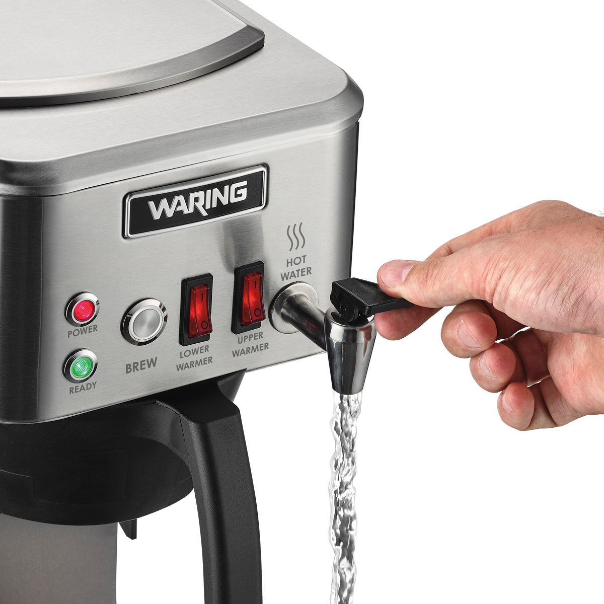 A hand dispenses hot water from a stainless steel Waring commercial coffee machine. The front panel features buttons labeled Power, Brew, Lower Warmer, and Upper Warmer with indicator lights, as water pours from the hot water spout into an unseen container.