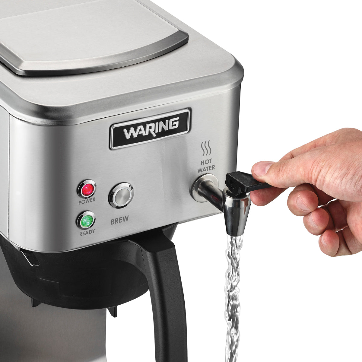 A hand dispenses hot water from a stainless steel commercial coffee brewer by turning a black lever. Water flows from the spout, and indicator lights labeled Power and Ready are lit on the machine's front panel above the Hot Water label.