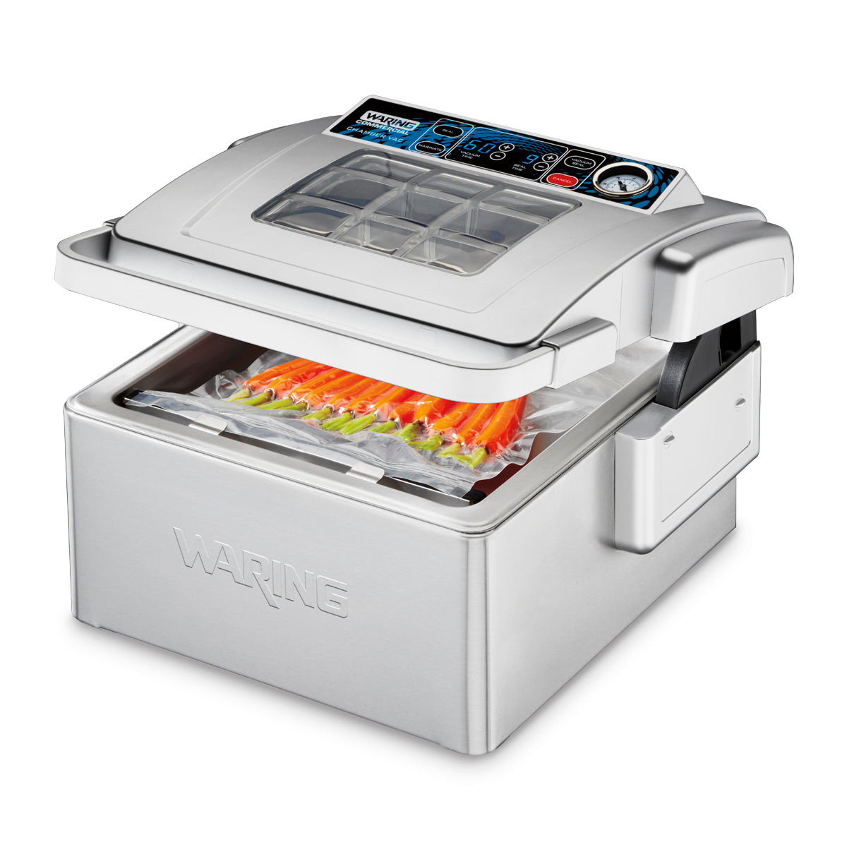 A stainless steel Waring Vacuum Packaging Machine sits on the countertop, its transparent lid partially open to reveal sealed bags of orange and yellow food items inside. The control panel on top includes buttons, a display screen, and a gauge.