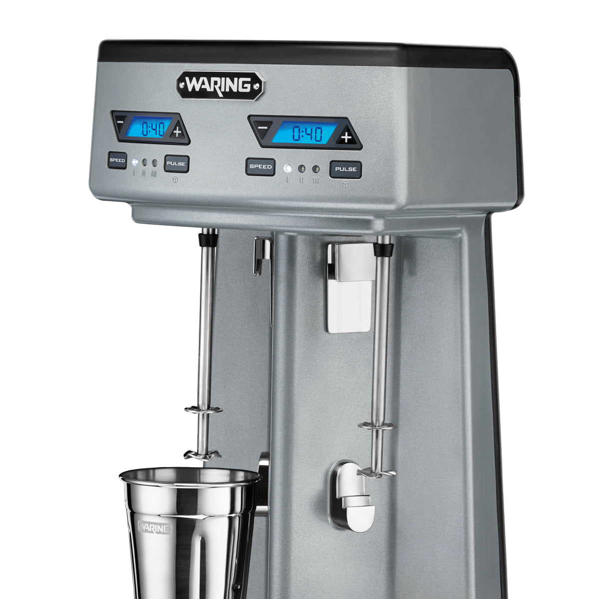 The Waring Double Spindle Drink Mixer features two mixing spindles, digital blue LED timers, control buttons for speed and pulse, and removable metal cups. The “Waring” brand label is displayed on the top front.