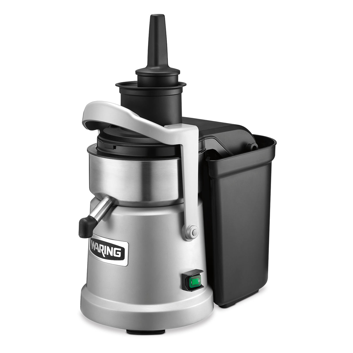 A heavy duty silver and black juice extractor with a cylindrical metal body, continuous pulp ejection, a side handle, top plunger, black plastic pulp container on the side, spout for dispensing juice, and a green power switch at the base.