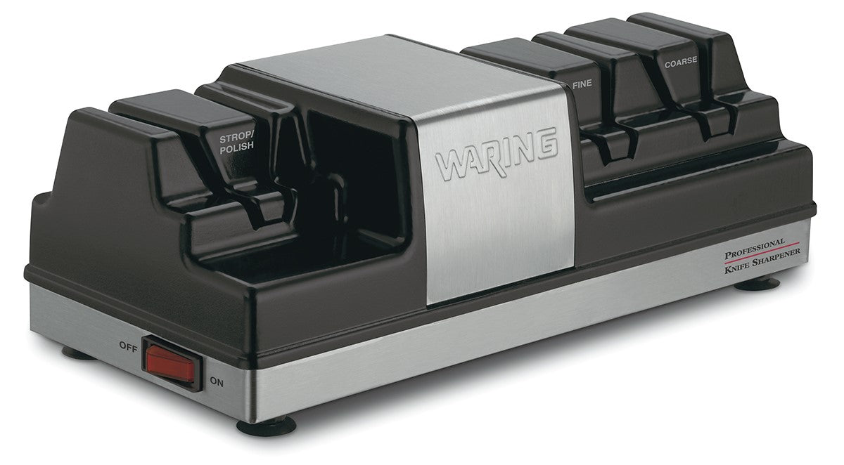A black and silver electric Knife Sharpener with labeled slots for Strop/Polish, Fine, and Coarse grinding wheels, a Waring logo on the metal front, red power switch at the base, and Professional Knife Sharpener text on the right side.
