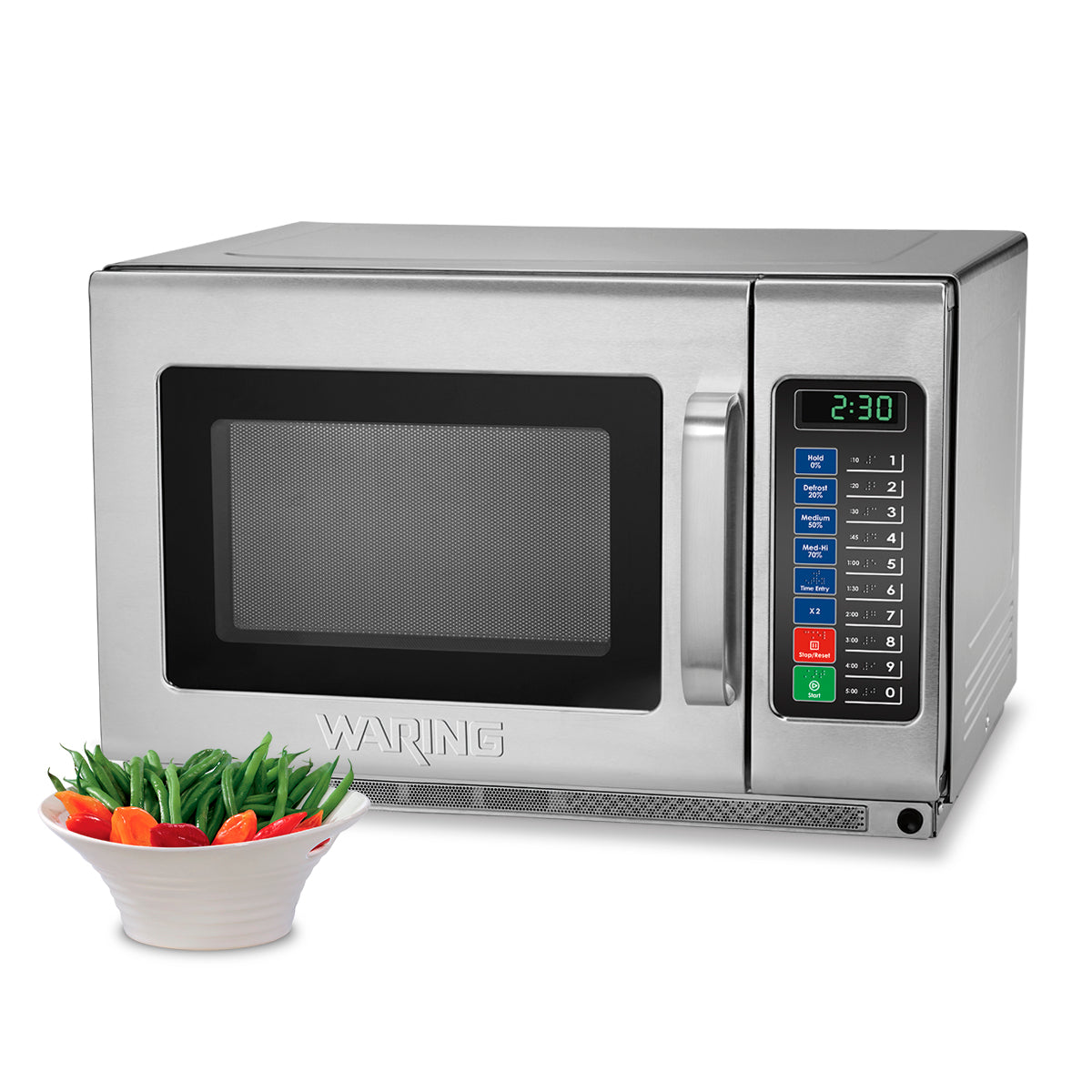 A stainless steel Waring commercial microwave oven with a digital keypad and display showing 2:30. In front of the heavy duty microwave oven is a white bowl filled with green beans, red bell peppers, and yellow bell peppers.