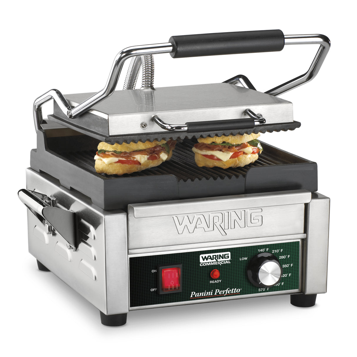 A stainless steel commercial panini grill with the lid open, grilling two panini sandwiches. The control panel reads Waring Commercial Panini Perfetto and features a red power switch, indicator lights, and a temperature dial. Ribbed cast iron plates ensure perfect grill marks.
