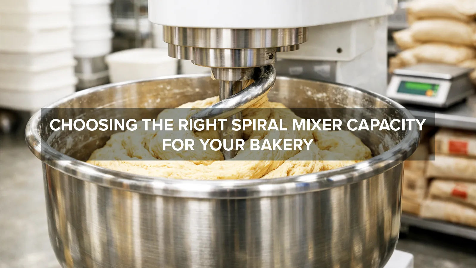 Spiral mixer in a commercial bakery mixing a large batch of dough to illustrate choosing the right mixer capacity